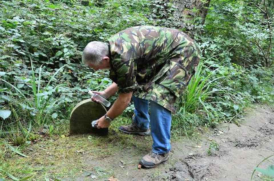 Hombre encuentra una lápida en medio del bosque con un dulce mensaje 10 Sid Saunders limpiando la lapida